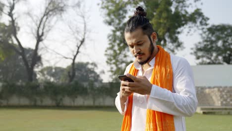 Indian-man-using-phone-in-traditional-wear