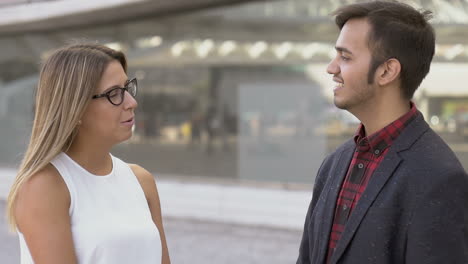 Smiling-man-and-woman-talking-on-street