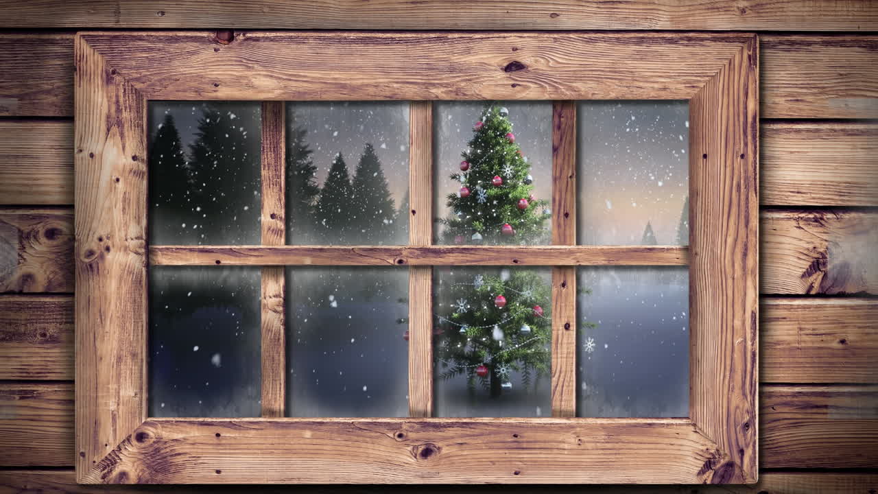 Wooden window frame against snow falling over christmas tree on winter landscape