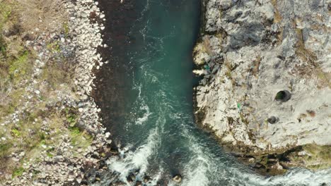 whitewater rapids, fast river water flowing over rocks, aerial top down view