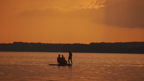 people relaxing on catamaran. silhouette of young friends chilling in catamaran boat