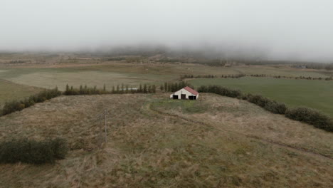 thick layer of fog above abandoned house, iceland