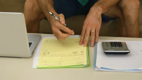 man with laptop accounting the bills