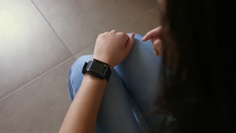 Young-woman-using-smartwatching