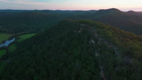 vibrant golden sunset lower mangrove blue mountains hawkesbury river creek nsw sydney cliffside edge australia aerial drone spring summer gum eucalyptus trees dharug popran forest forward motion