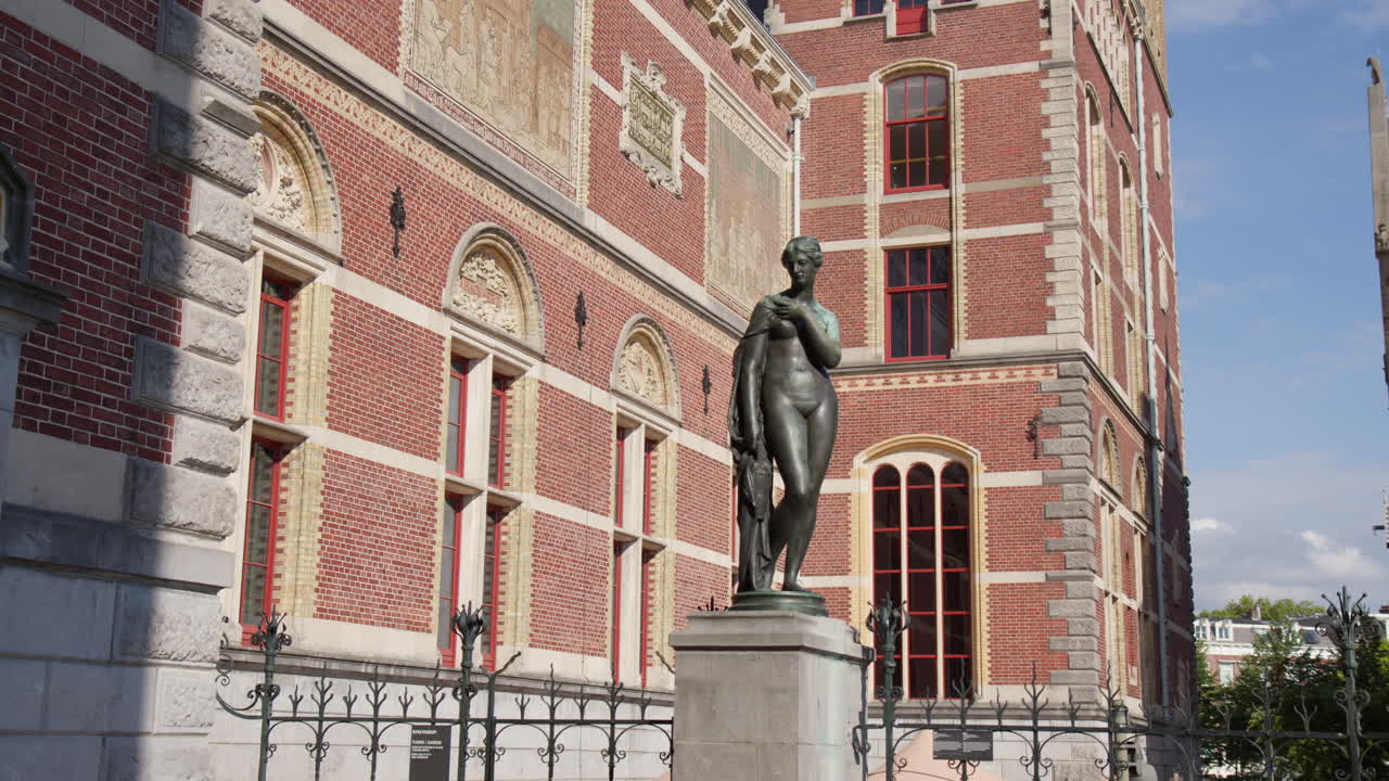 Bronze Statue Of A Woman In The Courtyard In Amsterdam, Netherlands - Low Angle Shot