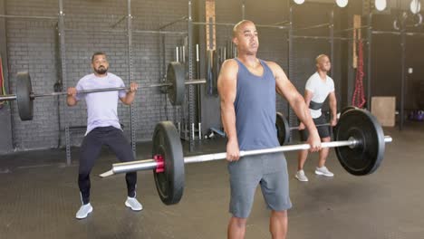 Portrait-of-focused-diverse-sports-people-exercising-at-gym-in-slow-motion