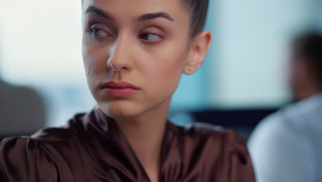 Displeased-businesswoman-working-in-office.-Female-employee-looking-away