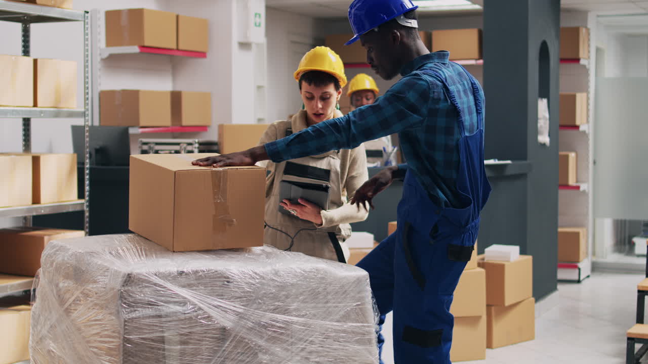 Warehouse workers handling cardboard boxes for shipping and inventory