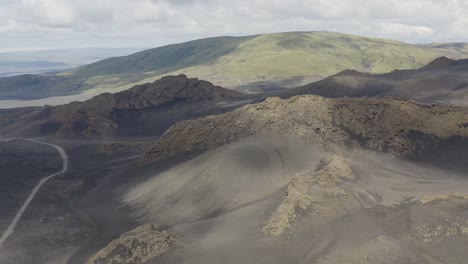 aerial orbit shot of volcanic landscape in the highlands of iceland - spectacular wide shot during cloudy sky