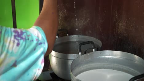 Chef-draining-noodles-from-boiling-water-with-a-strainer