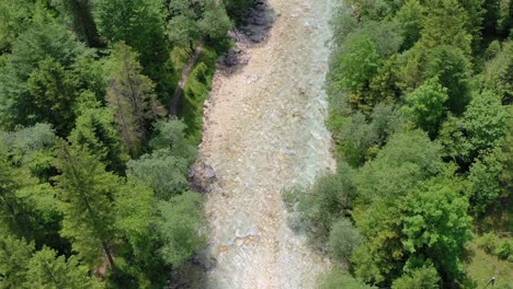 Medium-wide-angle-aerial-drone-shot-of-water-flowing-over-the-rocky-shelf-of-boka-waterfall-spring-during-the-day