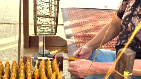 hands weaving silk in khao yai, thailand