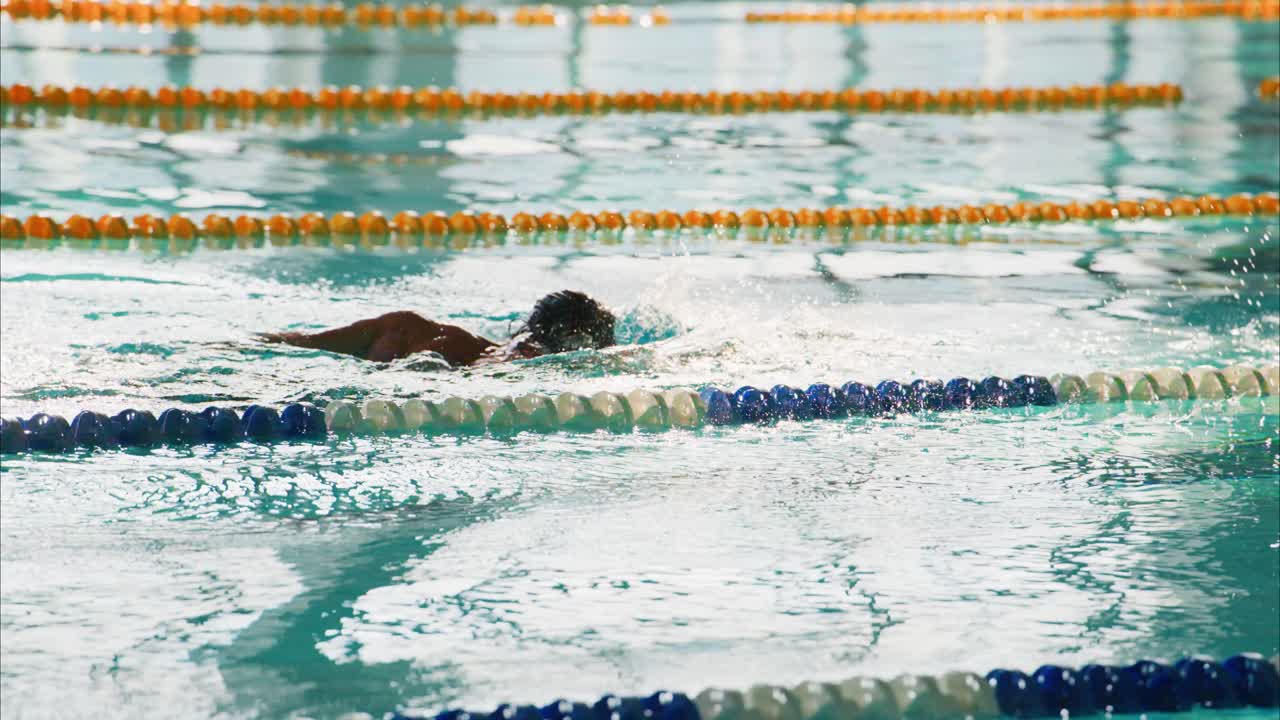 Competitive Swimmer in Action: Demonstrating Skill and Determination While Navigating the Pool Lanes, Capturing the Essence of Athletic Excellence and Focus