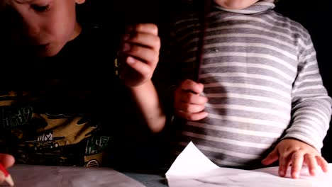 little children preschoolers draw together and jostle, close-up, camera movement
