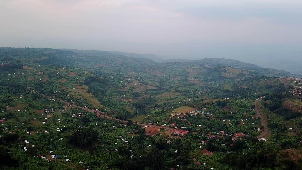 Aerial shot of Kapchorwa town in Eastern Uganda showing scattered rural houses, farmlands and rolling hills across a lush green highland landscape