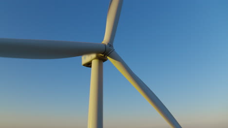 windmill propeller rotating in closeup. wind turbine producing renewable energy.