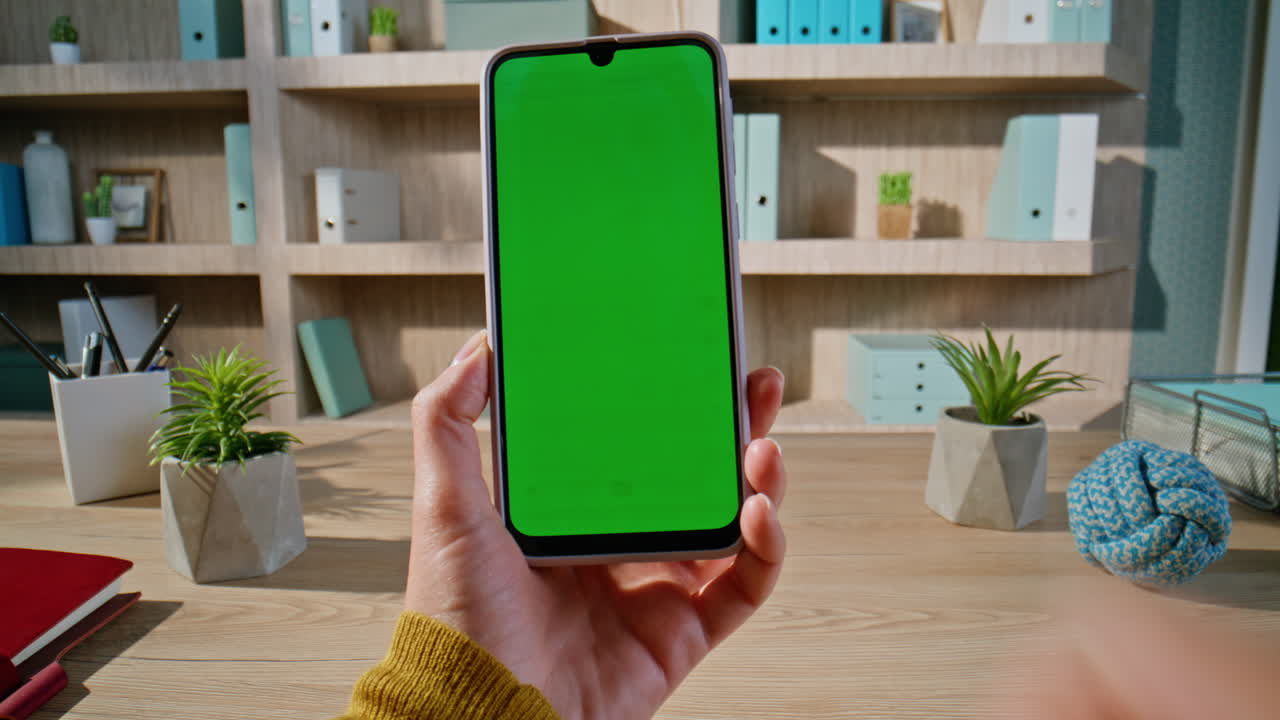 Lady hands using chromakey smartphone for online communication at office closeup