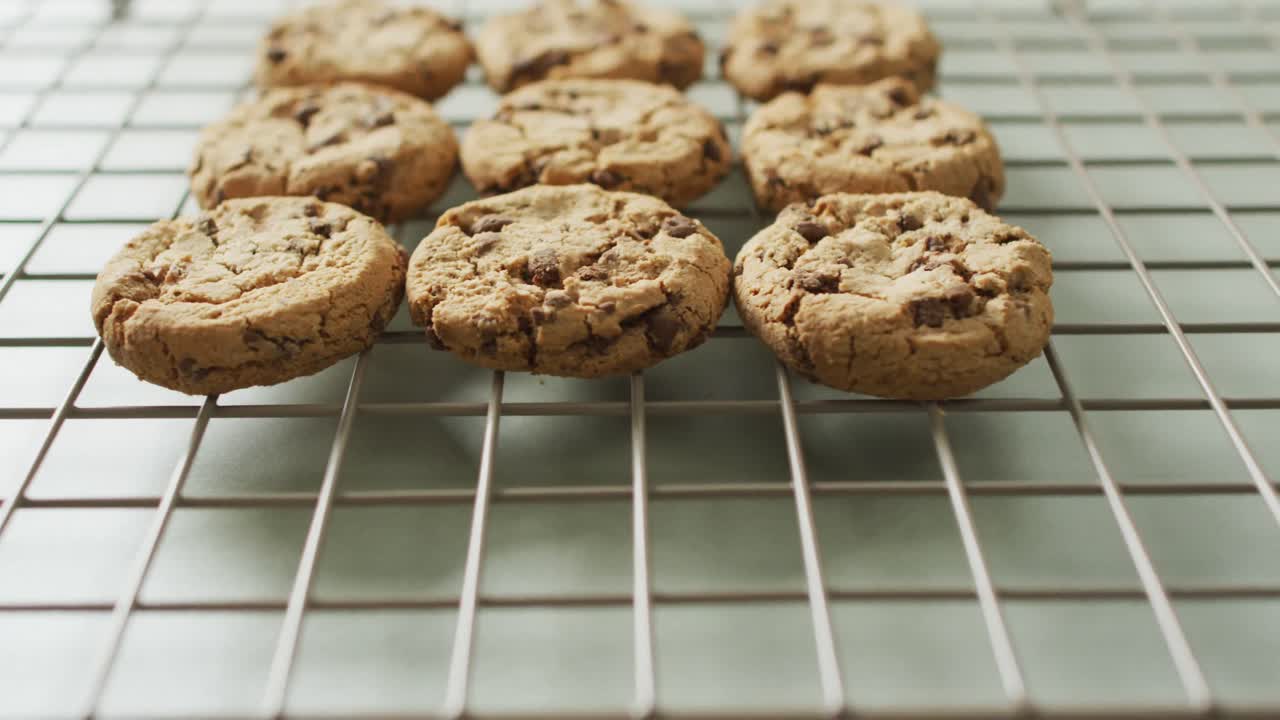 Video of rows biscuits on a baking rack over white background