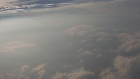 Motion-shot-from-the-window-of-an-airplane-with-beneath-and-above-during-sunset