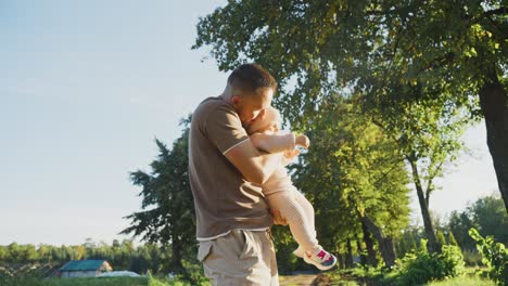 father and baby girl in a park