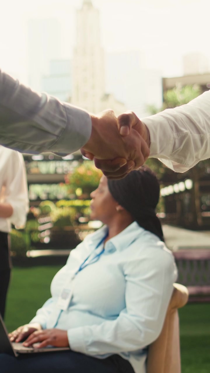 Vertical Video Close up handshake agreement during outdoor negotiations