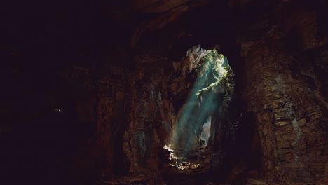 mysterious cave illuminated by sunlight filtering through natural openings