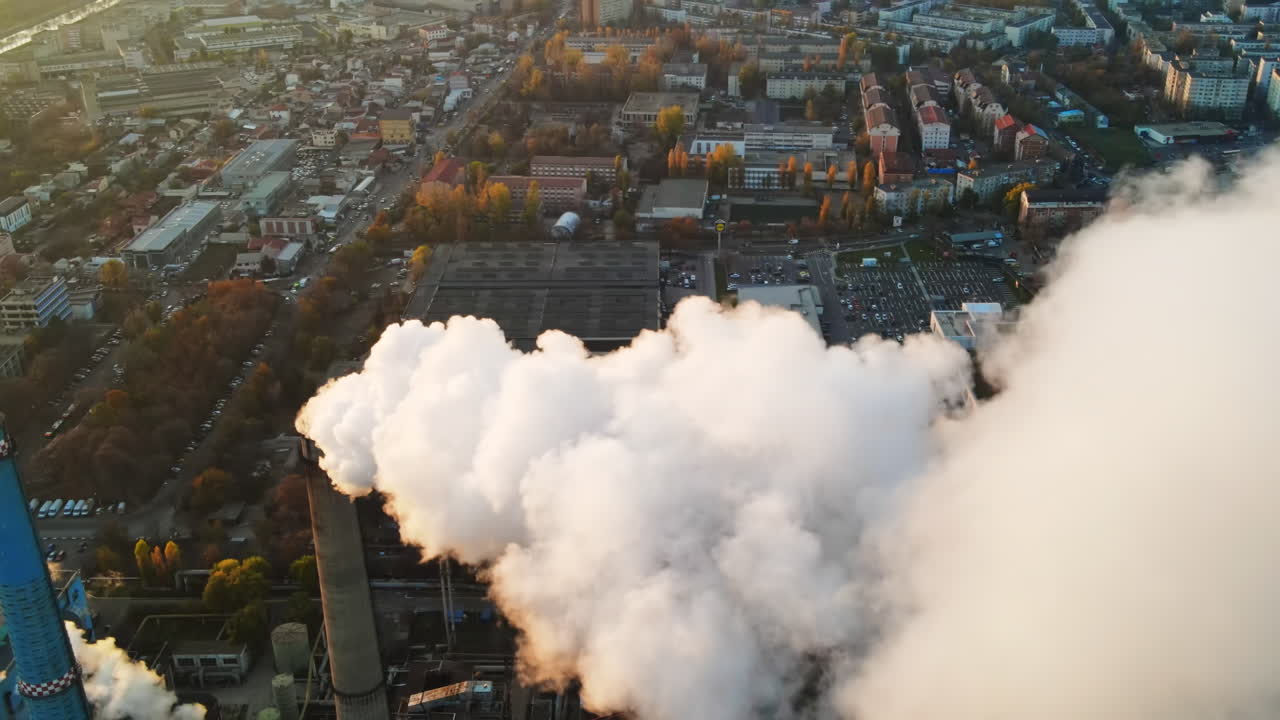 Power station with a lot of tubes and facilities in Bucharest at sunset, a lot of foam. Cityscape, view from the drone, Romania