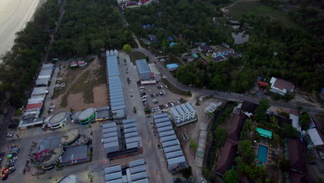 Overhead-aerial-shot-of-Ao-Nang-town-by-beach-in-evening,-tilt-up,-Thailand