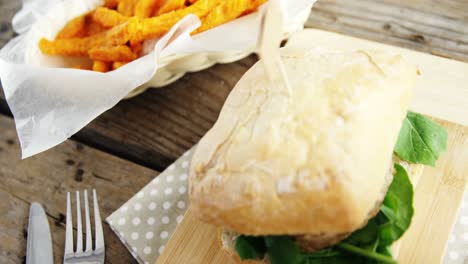 hamburger and french fries on wooden table