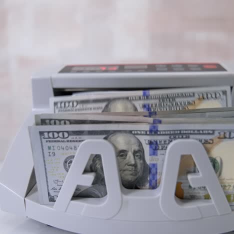 money counting machine. counting dollar banknotes