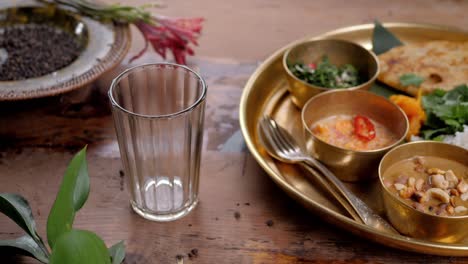 indian tea, masala tea, masala chai, herbal tea, spice tea with gujarati dahitra sweet pouring slow motion with carry traditional rice fish chicken