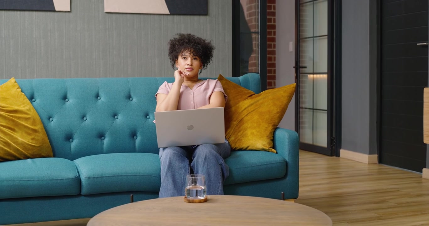 Female coworkers passing as woman glancing, resuming typing to continue work on laptop in office