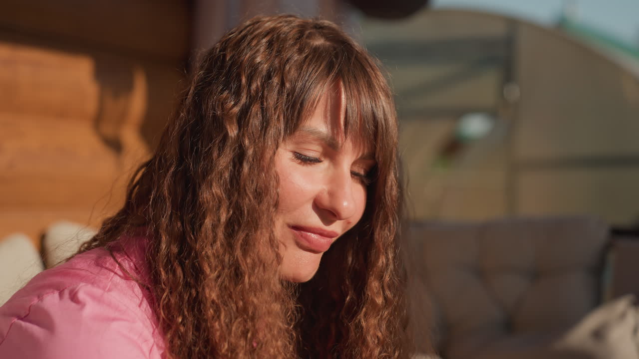 Woman Enjoys Sunny Porch, Relaxed Lady Basks In Sunlight, Woman Peacefully Absorbs Warm Summer Rays Outdoors, Caucasian Female Relaxes With Closed Eyes In Outdoor Sunlight Atmosphere