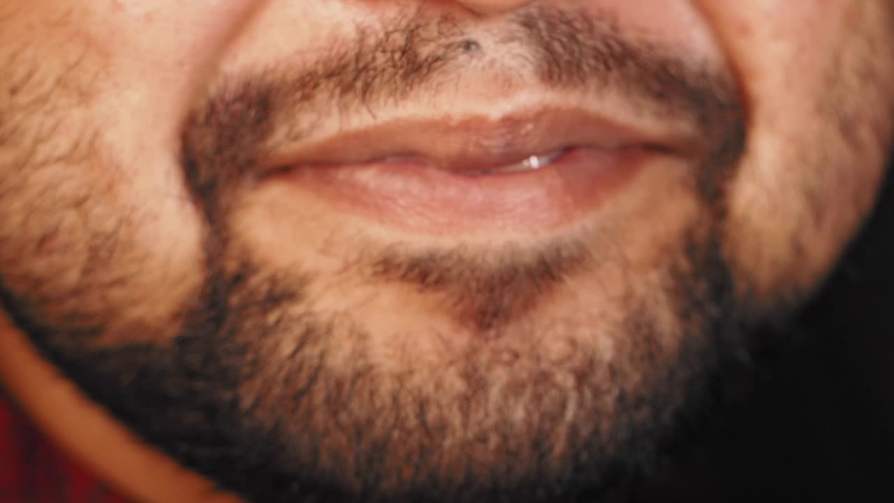 Close-up of a man's face with beard and lips