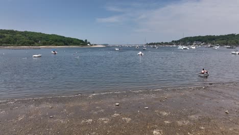 a low angle view from scudder park heading to northport marina on long island with anchored boats