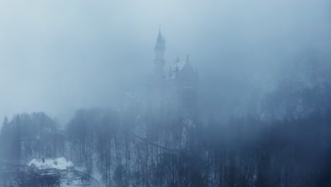 neuschwanstein castle in a foggy winter landscape