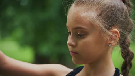a young girl in a natural setting displays contemplation and serenity, captured in two distinct frames reflecting her transition from awareness to calmness