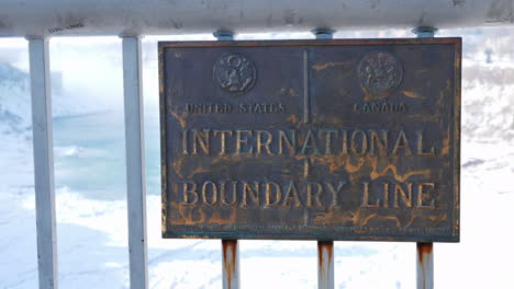 the plate on the rainbow bridge indicating the location of the border of the united states and canad