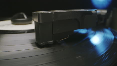 closeup of hand of anonymous black man lowering tonearm on turntable closeup view of hand of anonymous black man lowering tonearm on turntable after putting vinyl record on it