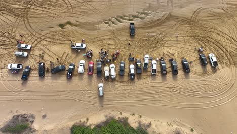 drone shot revealing aftermath of car drifting race at gadani beach alongside arabian sea, balochistan, pakistan