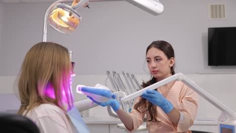 a skilled dental professional is performing a teeth whitening procedure that utilizes led lights effectively.
