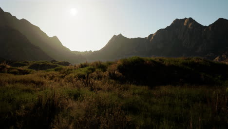 cordillera iluminada por el sol con pastizales verdes