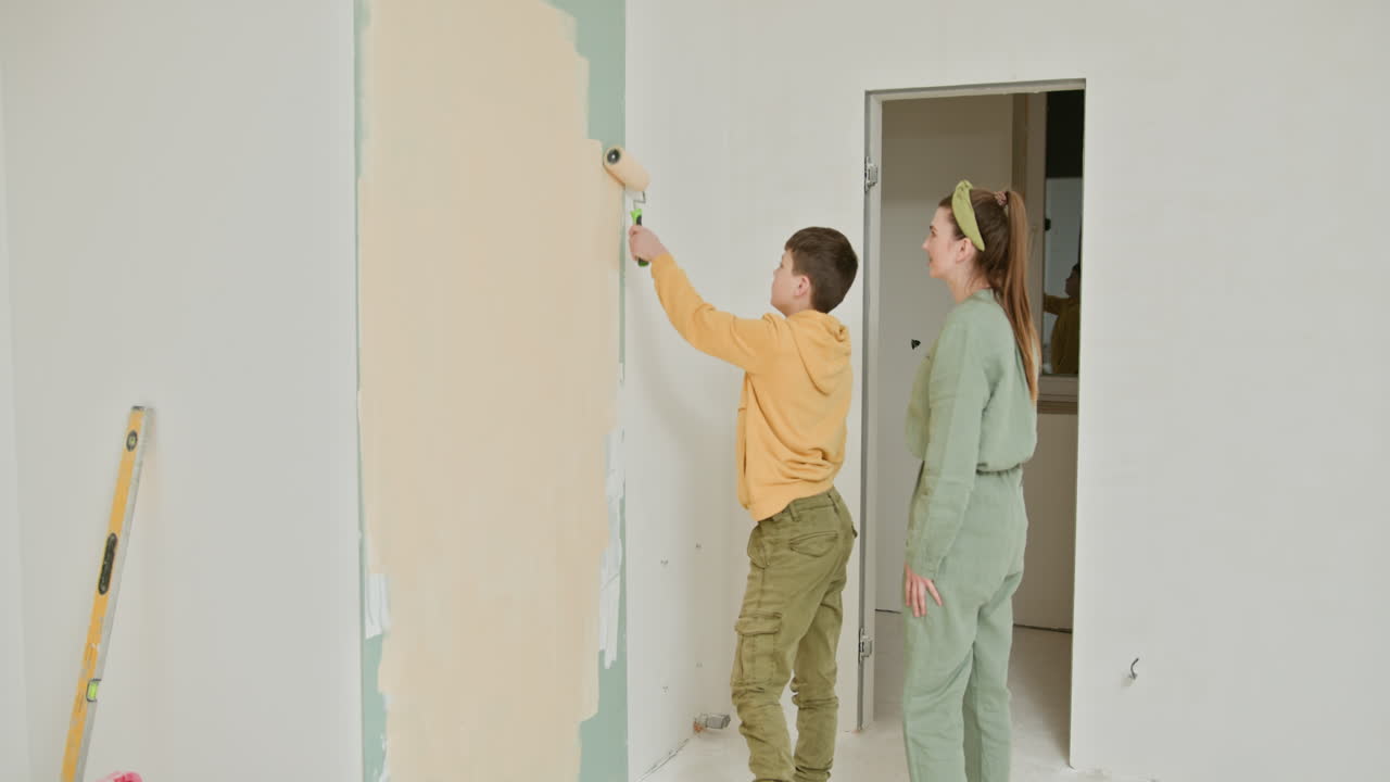 Mother and Son Painting a Wall Together