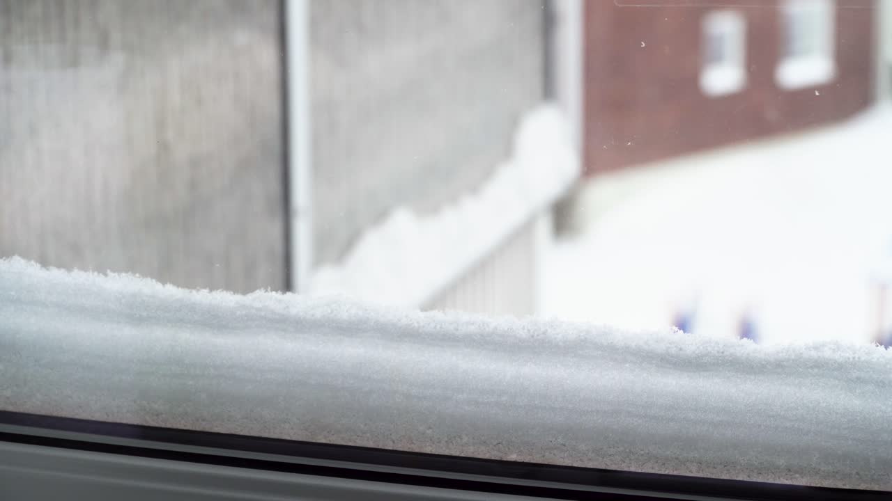 Close up shot of snow just outside the window