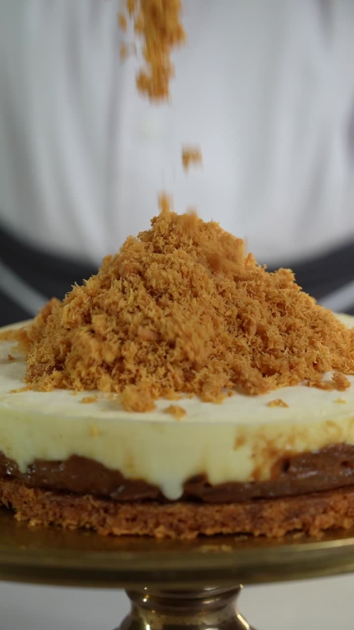Close-up of a Chef Decorating a Delicious Layered Caramel Cake