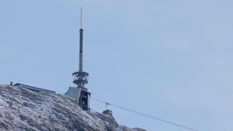 one of the ulriksbanen cable cars just as it reaches the upper station at mount ulriken at a sunny winter day