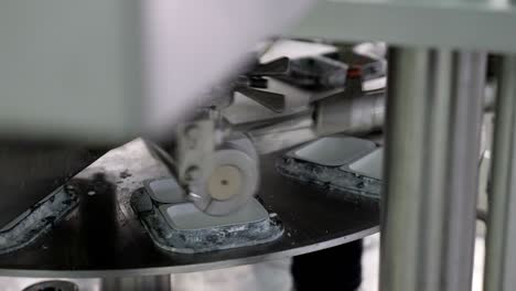Cheese spread production line, the cheese spread is being filled into plastic box containers
