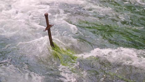 cheddar, somerset, england, december 28, 2019: sword in the middle of a water stream