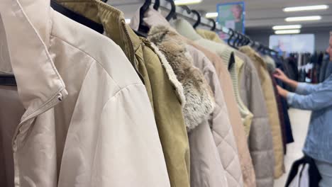 sale of winter clothes in the shopping center sale of clothes at autumn discounts woman shopping sale of winter clothes in the shopping center sale of clothes at autumn discounts woman shopping blurred background